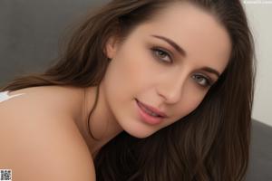 A pregnant woman holding a dildo in her hand.