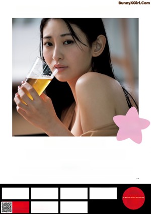 A woman in a white bra top eating a piece of food.
