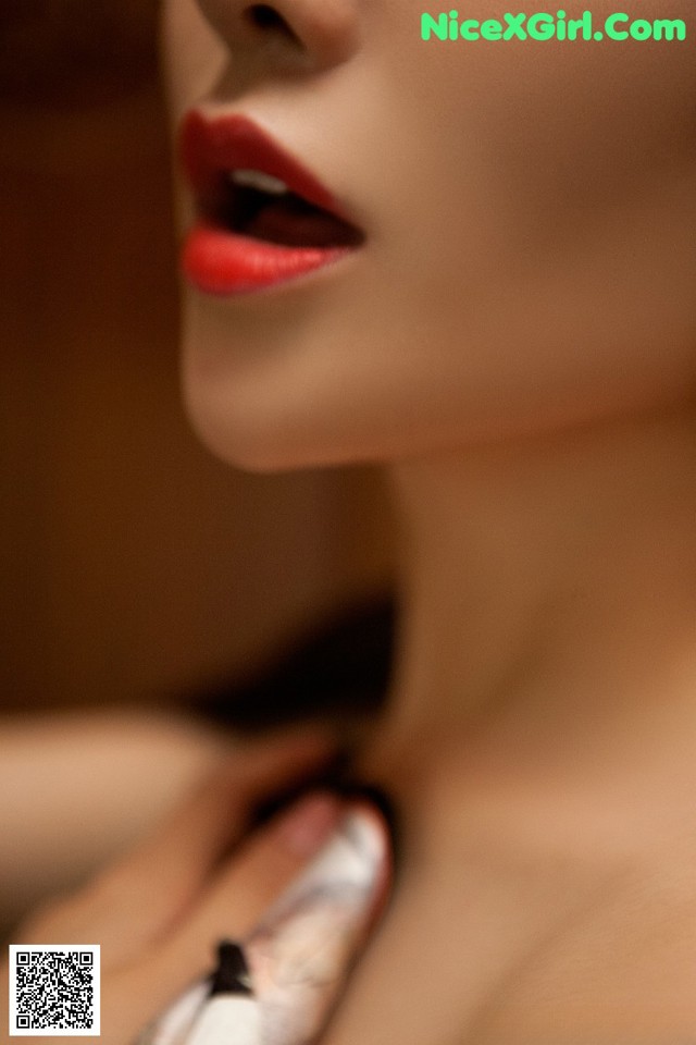 A close up of a woman's face with red lipstick.