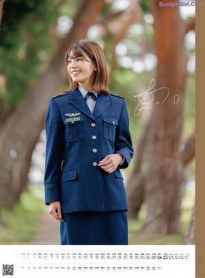 A woman in a blue uniform posing for a calendar.