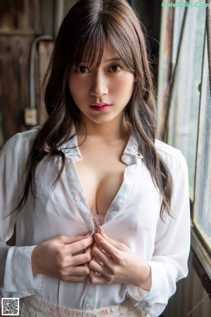 A woman in a white shirt and a white lace skirt.