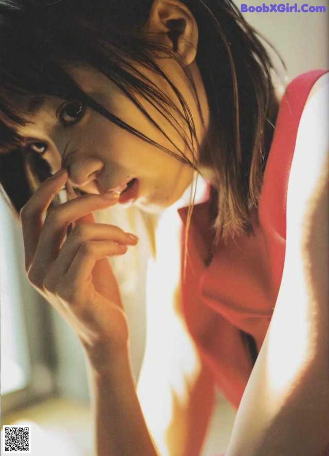 A woman in a red dress smoking a cigarette.
