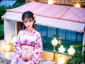 A woman in a pink kimono posing for a picture.