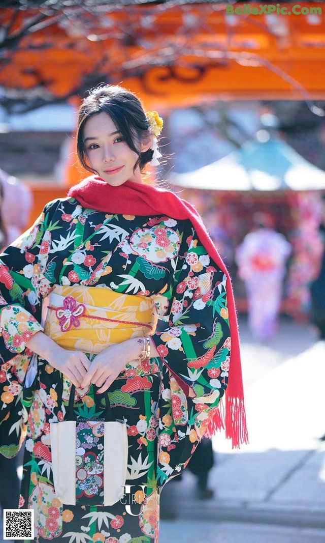 A woman in a kimono is posing for a picture.