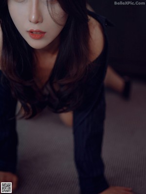 A woman sitting at a desk with her legs crossed.
