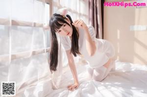 A woman laying on a bed with white stockings.