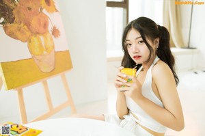 A woman sitting at a table with chopsticks in front of her.